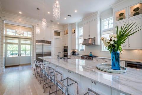 Juliska lanterns float over quartzite counter top which seats 6.  