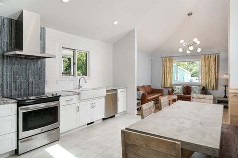 The Open Kitchen has High Ceilings and Stainless Steel Appliances. 