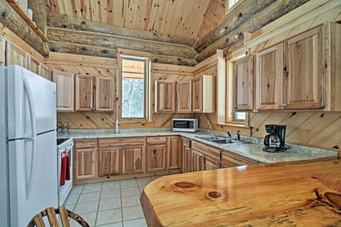 The well-equipped kitchen boasts wood cabinetry and ample counter space.