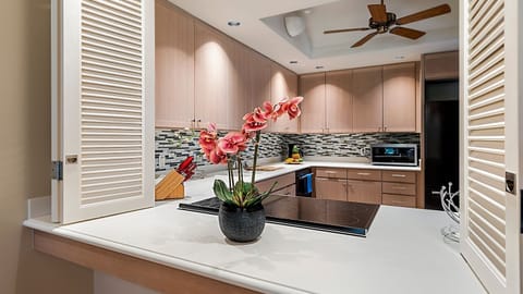 Kitchen with Cooktop, Refrigerator, Ceiling Fan, and Microwave