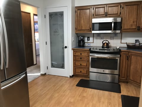 Pantry, professional range, microwave and a French Door refrigerator.