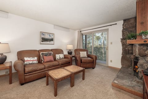 Sink into plush leather seating by your crackling stone fireplace, where cozy mountain evenings come alive with warmth and comfort.