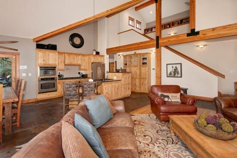 Main level living area with big screen smart TV and gas fireplace.