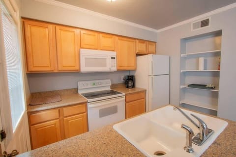 Fully equipped kitchen with pots, pans, plates, bowls, utensils, fire extinguisher and everything you need for meals