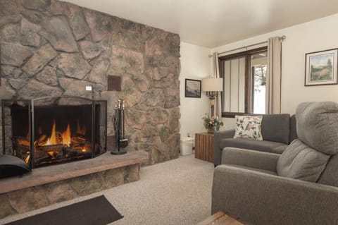 Curl up by your crackling stone fireplace with plush seating that invites relaxation after mountain adventures.