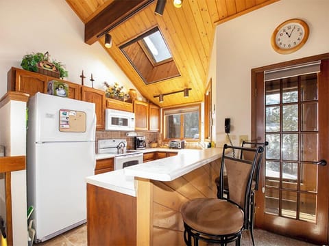 Your fully equipped kitchen features warm wood details, skylight views, and everything you need to create memorable meals during your stay.