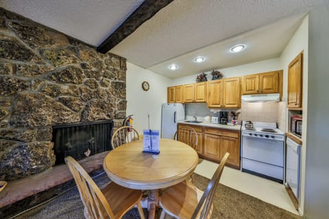 Your cozy kitchen-dining combo features rustic stone fireplace warmth, full appliances, and intimate dining for memorable meals together.