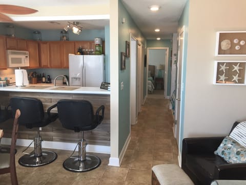 View of kitchen and hall from living room