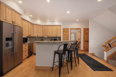 Your gourmet kitchen awaits with granite counters, stainless appliances, and cozy breakfast bar seating for morning coffee conversations.