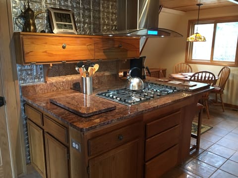 Kitchen range, with kitchen nook seating.