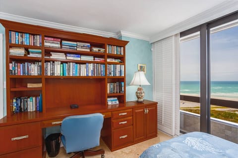 Guest bedroom 2 twin beds, sliding doors open wide to an open air balcony. Large desk to catch up on work if needed.