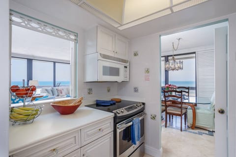 Kitchen has tile floors and ample counter space to enjoy homemade meals if you prefer.