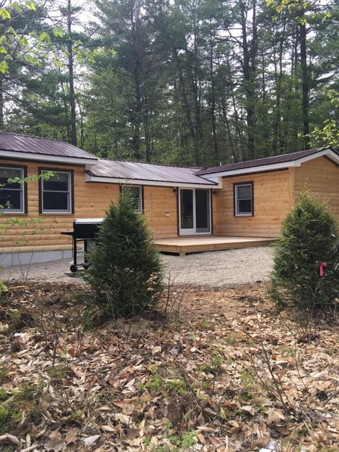Side of house with porch area and fire pit