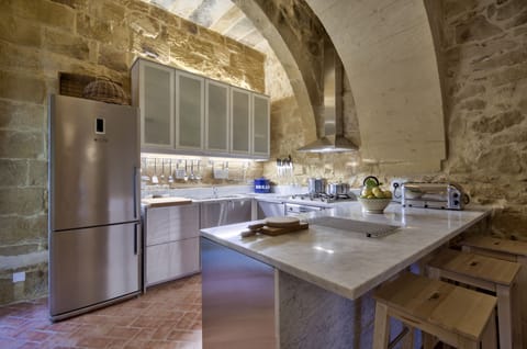 The modern, fully equipped stainless steel kitchen with it's Carrara marble tops