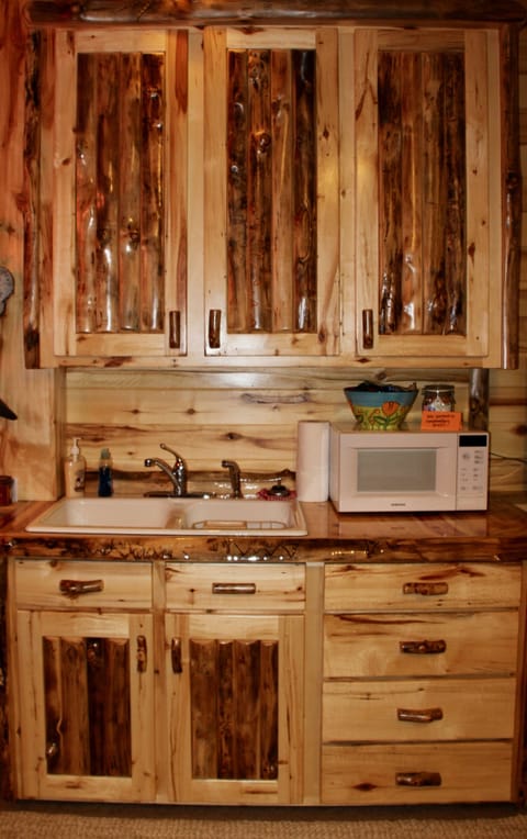 Sink, microwave, small fridge, dishes, coffee maker, silverware.......