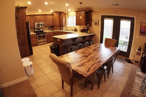 Kitchen and dining room table, seating for 8-10 people. 