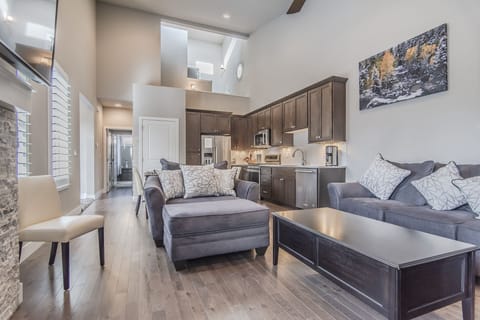 Living Area - Queen size sofa sleeper, fireplace, flat screen TV, and access to private patio.