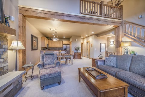 Living Area - Queen size sofa sleeper, flat screen TV, fireplace, and access to the private balcony.