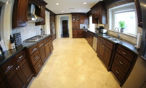 Gourmet Kitchen with Granite Countertops, Stainless Steel Appliances and Travertine Floors