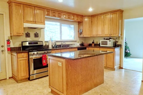 Chef's kitchen, with lots of cooking equipment including a convection oven.