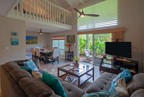 Puamana 25B living room - The living room has plenty of space for you to stretch out and unwind after a long day! Enjoy a family-style meal at the dining table that can seat 8, and then relax on the couch with your favorite movie.