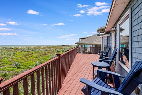 Expansive deck offers stunning natural landscape views beneath endless blue skies and fluffy white clouds.