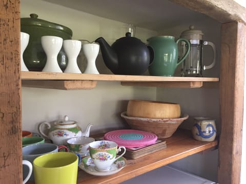 The kitchen is very well stocked with crockery.