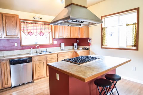 Large kitchen with bar seating located off the dining area