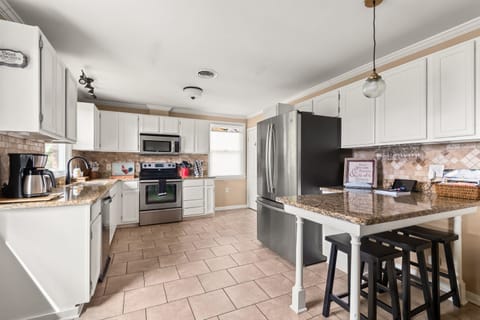 Drip-pot coffee maker, tea kettle, toaster, blender, and fully stocked cookware, bakeware, and diningwear.