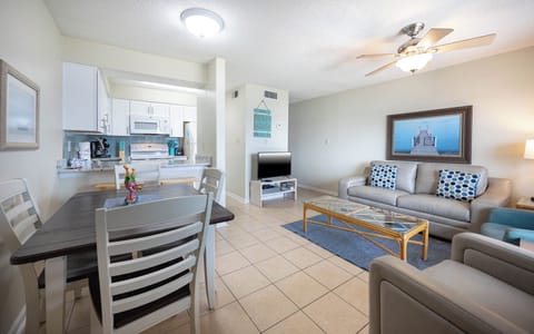 This inviting living area features a cozy couch, a TV, and a dining table, perfect for relaxing after a day of fun