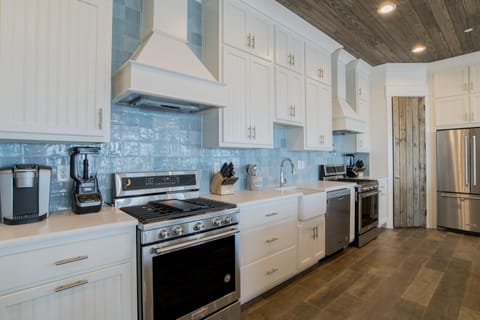 Kitchen with 3 dishwashers, 3 full size refrigerators, 2 gas range cook tops and and 4 ovens.