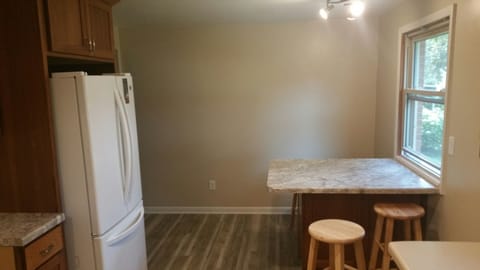 Newly Remodeled Kitchen with Bar looking out to backyard.