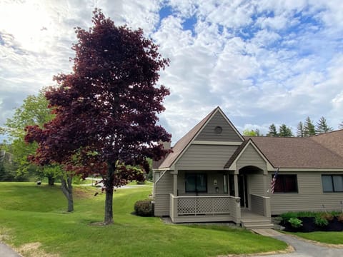 Positioned along the scenic golf course with stunning views of the Presidential Range