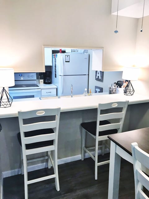 Dining view into kitchen; has an eat in area counter