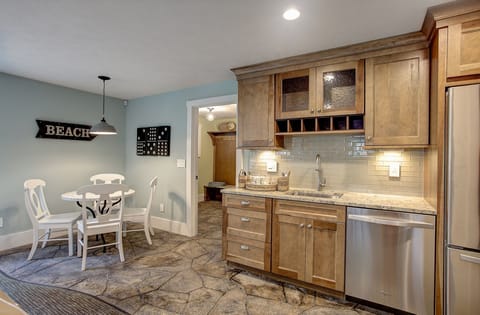 Basement wet bar with fridge, dishwasher and full set of outdoor dishes