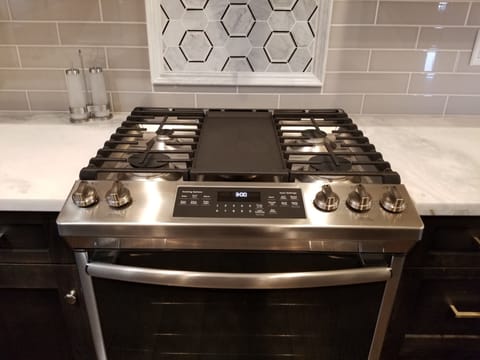 White Granite Countertops and Gas Range