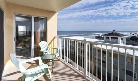 Balcony with simple furniture and a view onto the area.