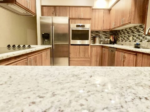 Beautiful kitchen fully stocked to cook and serve for everyone. Grill on patio.