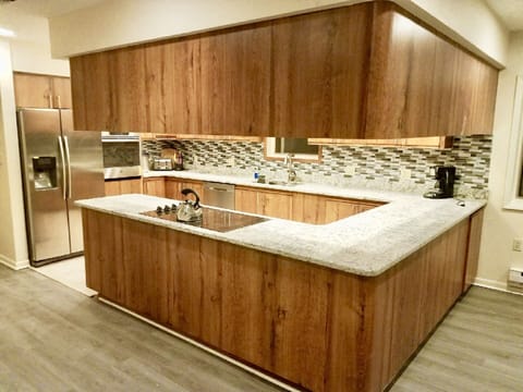 Beautiful eat in kitchen fully stocked to cook and serve for family gatherings.
