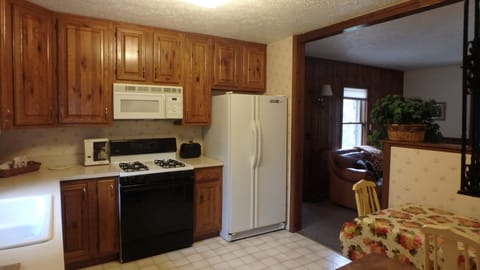 beautiful rustic oak cabinets  in kitchen with seating for 4.