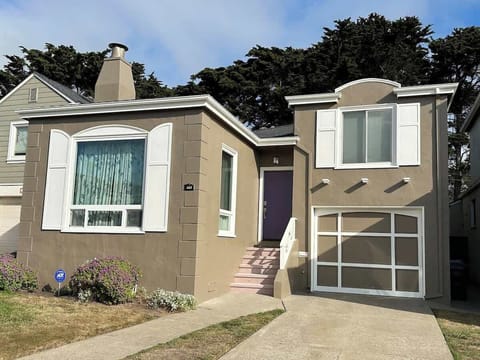 Charming home exterior with a private driveway, garage, and welcoming entry—perfect for a comfortable stay.