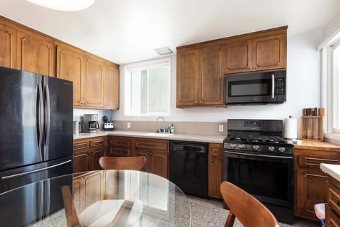 Bright kitchen and dining area featuring classic cabinetry and a comfortable table for everyday dining.
