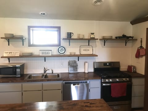 Kitchen with new gas range and dishwasher 
