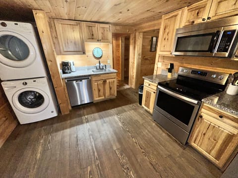Cozy rustic kitchen with modern appliances and laundry amenities
