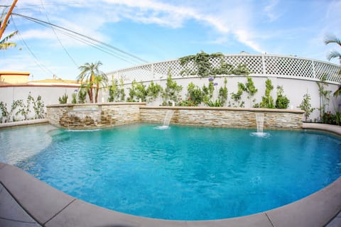 In-ground Pool and Spa with Waterfall Features and Baja Shelf