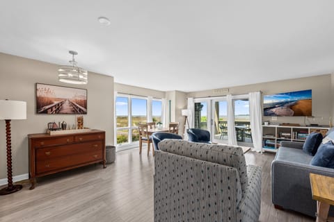 A beautiful wall of windows greets you with the beach beyond in the end unit.