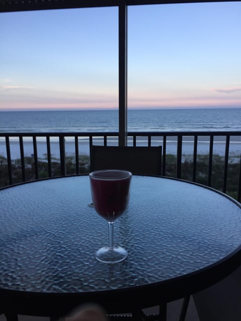 Wine at Sunset on 305 oceanfront balcony with polywood  table and 4 chairs
