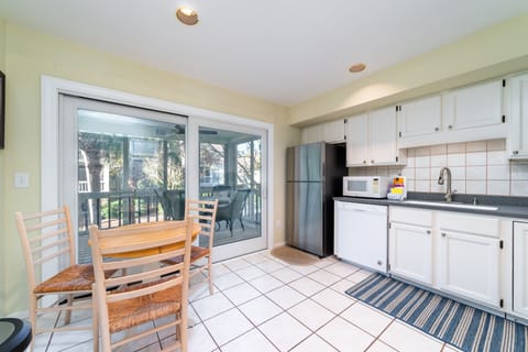 Sliding doors off the kitchen lead to the screen porch