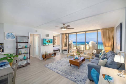 Living room with pull-out sleeper sofa, 2 chairs, smart TV, ceiling fan, and great ocean views.