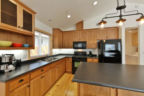fully stocked kitchen with gas range stove and espresso maker